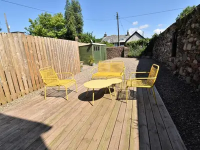 a patio with a table and chairs and a fence at 4 Bed in Seascale oc-85807 in Gosforth