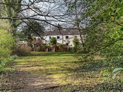 a house in the middle of a field with trees at 2 Bed in Keswick oc-87092 in Keswick