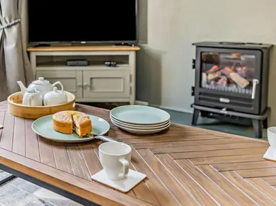 a living room with a table with a plate of food at 2 Bed in Keswick oc-87092 in Keswick