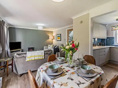 a living room with a table with flowers on it at 2 Bed in Keswick oc-87092 in Keswick