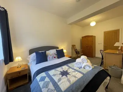 a bedroom with a bed with towels on it at Langrigg Cottage HOT TUB HIRE AVAILABLE in Portinscale