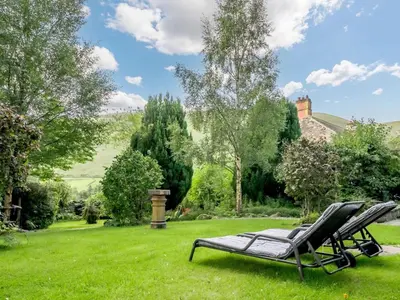 a bench sitting in the grass in a yard at 1 Bed in Penrith oc-88201 in Mosedale