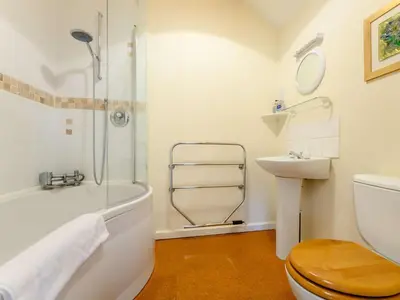 a bathroom with a shower and a toilet and a sink at 1 Bed in Penrith oc-88201 in Mosedale