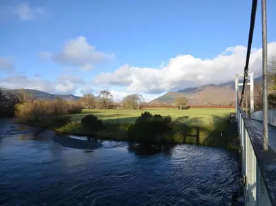 a bridge over a river next to a golf course at 2 Bed in Keswick 88864 in Keswick
