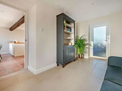 a living room with a couch and a book shelf at 5 Bed in Wigton oc-89496 in Torpenhow