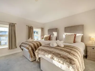 a bedroom with two beds and a window at 5 Bed in Wigton oc-89496 in Torpenhow