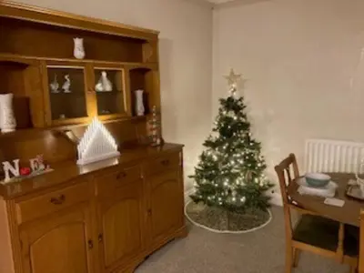 a living room with a christmas tree in the corner at 3 Bed in Aspatria 89139 in Aspatria