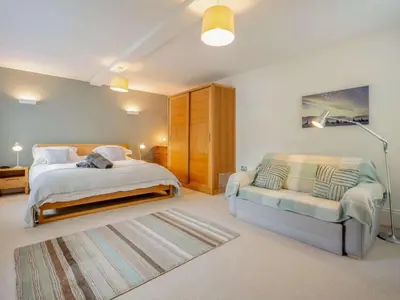 a large bedroom with a bed and a couch at 2 Bed in Keswick oc-89257 in Keswick