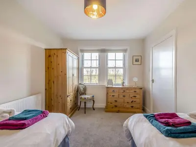 a bedroom with two beds and a dresser and a window at 2 Bed in Ayr 90039 in Ayr