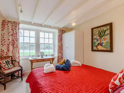 a bedroom with a red bed and a desk and a window at 4 Bed in AYR 90038 in Ayr