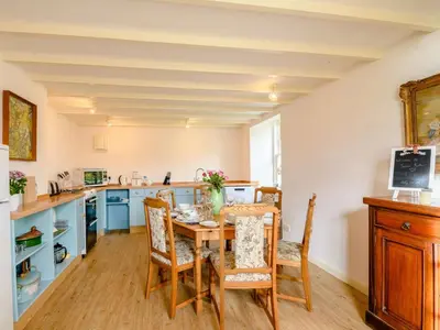 a kitchen with a table and chairs in a room at 4 Bed in AYR 90038 in Ayr