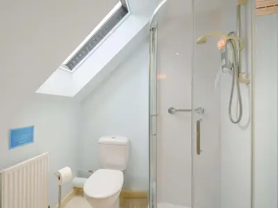 a bathroom with a toilet and a glass shower at 4 Bed in AYR 90038 in Ayr