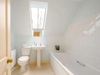 a bathroom with a toilet and a sink and a bath tub at 4 Bed in AYR 90038 in Ayr