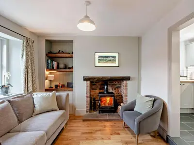a living room with a couch and a fireplace at 2 Bed in Keswick oc-90064 in Threlkeld
