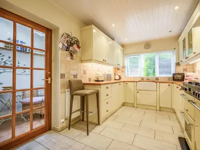 a kitchen with white cabinets and a stool at 2 Bed in Keswick oc-sz427 in Keswick