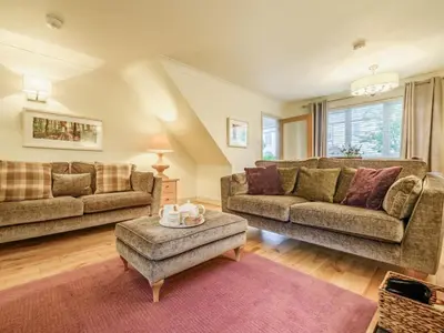a living room with two couches and a table at 2 Bed in Keswick oc-sz427 in Keswick