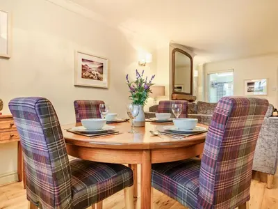 a dining room with a wooden table and chairs at 2 Bed in Keswick oc-sz427 in Keswick