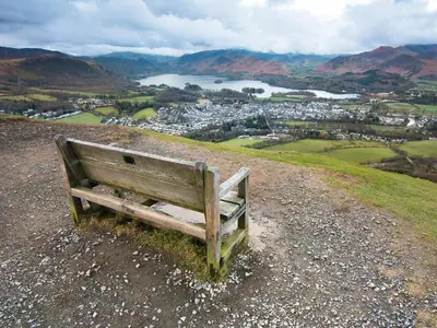 a wooden bench sitting on top of a hill at 1 Bed in Ullswater 90300 in Penruddock
