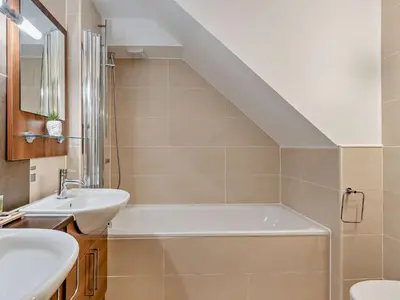 a bathroom with a sink and a bath tub at 1 Bed in Ullswater 90300 in Penruddock