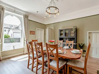 a dining room with a wooden table and chairs at 6 Bed in Keswick oc-90333 in Keswick