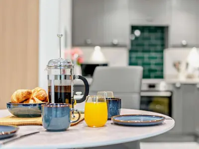 a table with a jug of orange juice and bread at 2 Bed in Dearham 91132 in Dearham