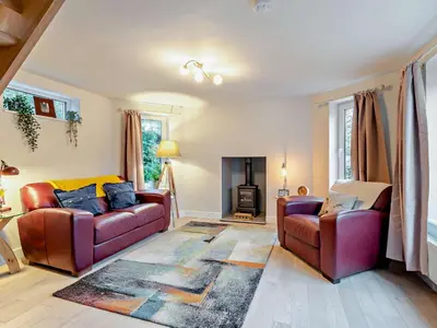 a living room with two couches and a fireplace at 2 Bed in Dearham 91132 in Dearham
