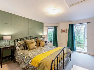 a bedroom with a bed and a large window at 2 Bed in Dearham 91132 in Dearham