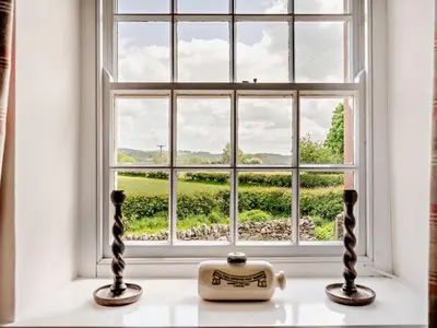 a window with a view of a green field at 1 Bed in Mosedale 91232 in Mosedale