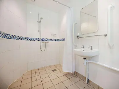 a bathroom with a shower and a sink and a tub at 1 Bed in Mosedale 91232 in Mosedale
