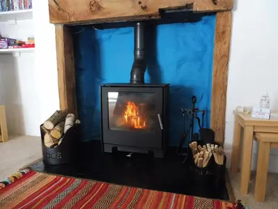 a fireplace with a stove in a living room at 2 Bed in Glenridding 90874 in Glenridding