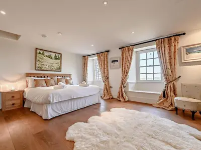 a bedroom with two beds and a rug at 5 Bed in Cockermouth oc-91503 in Embleton