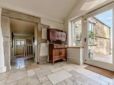 a large room with a stove and a window at 5 Bed in Cockermouth oc-91503 in Embleton