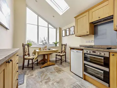 a kitchen with a table and a dining room at 1 Bed in Penrith oc-91812 in Dockray