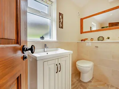 a bathroom with a toilet and a sink and a window at 1 Bed in Penrith oc-91812 in Dockray