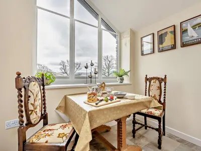 a dining room with a table and two chairs at 1 Bed in Penrith oc-91812 in Dockray
