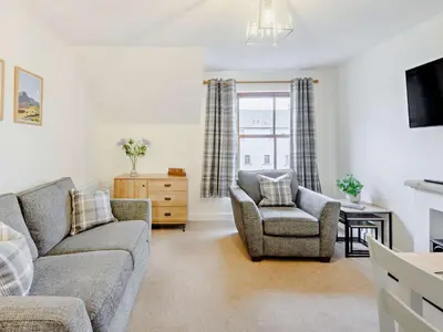 a living room with a couch and a chair at 2 Bed in Keswick 91901 in Keswick