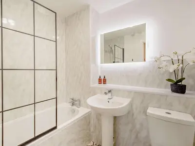 a bathroom with a sink and a toilet and a mirror at 2 Bed in Keswick 91901 in Keswick