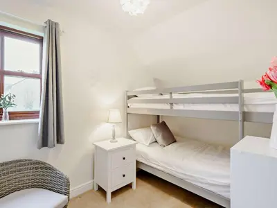 a bedroom with two bunk beds and a window at 2 Bed in Keswick 91901 in Keswick