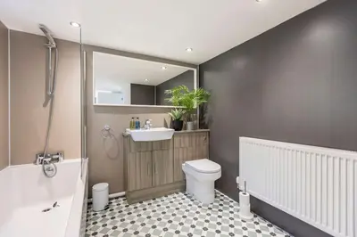 a bathroom with a tub and a toilet and a sink at Langdale Boulders, Ambleside, Fantastic views in Chapel Stile