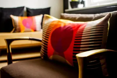 a pillow sitting on a chair in a living room at Langdale Boulders, Ambleside, Fantastic views in Chapel Stile