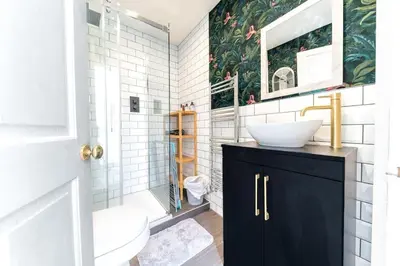 a bathroom with a sink and a toilet and a mirror at Charming Cottage, Lake District in Little Broughton