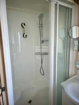 a shower in a bathroom with a glass door at Bay 1 in Kirkcolm