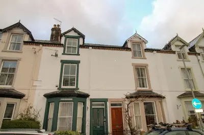 a large white house with green trim at Carlton Cottage all ground floor, centrally located in Keswick in Keswick