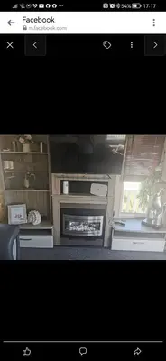 a picture of a kitchen with a fireplace at Birds Eye View in Mainsriddle