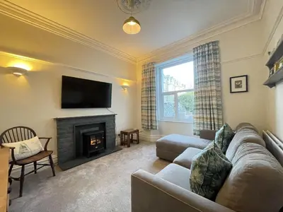 a living room with a couch and a fireplace at Ellergill in Keswick