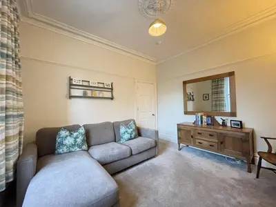 a living room with a couch and a mirror at Ellergill in Keswick