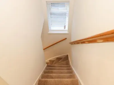 a staircase in a house with a window at Jack's Cottage in Keswick