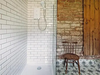 a chair sitting in a shower next to a bath tub at Top Lodge in Carlisle