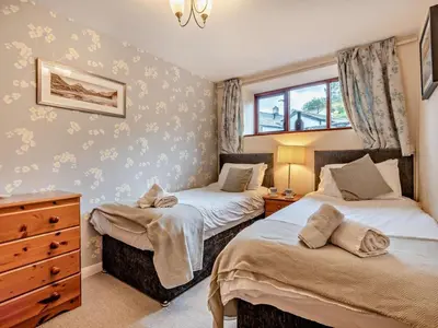 a bedroom with two beds and a dresser at 2 Bed in Keswick oc-28383 in Braithwaite