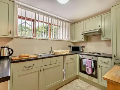 a kitchen with white cabinets and a sink at 2 Bed in Keswick oc-28383 in Braithwaite